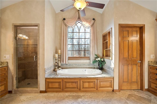 bathroom with lofted ceiling, a stall shower, a bath, and vanity