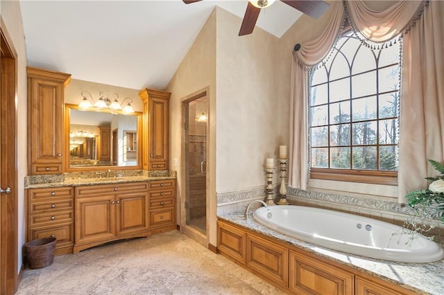 bathroom featuring a stall shower, lofted ceiling, a garden tub, and vanity