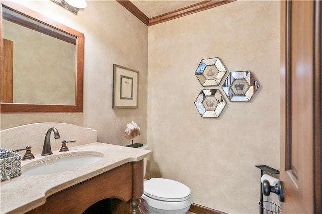 bathroom with toilet, crown molding, and vanity