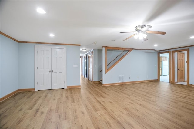 interior space featuring light wood finished floors, baseboards, visible vents, crown molding, and recessed lighting