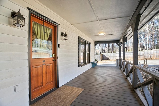 wooden deck with covered porch and fence