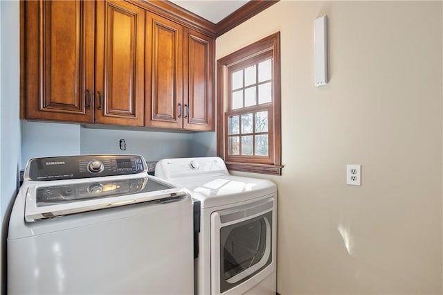 laundry area with cabinet space and separate washer and dryer