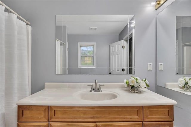 full bath with visible vents and vanity