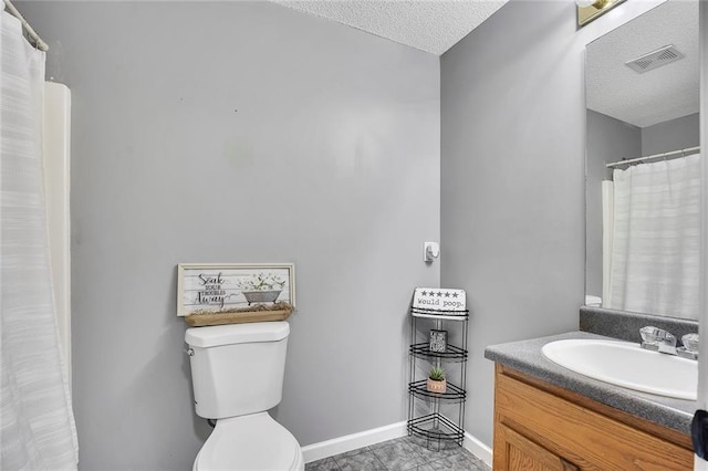 full bathroom with vanity, toilet, a textured ceiling, baseboards, and visible vents
