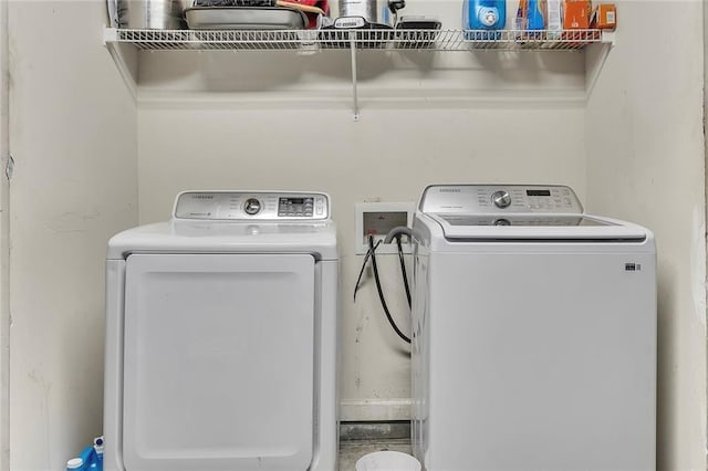 washroom featuring washing machine and clothes dryer and laundry area