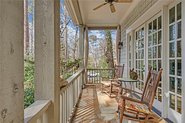 balcony with a porch and a ceiling fan