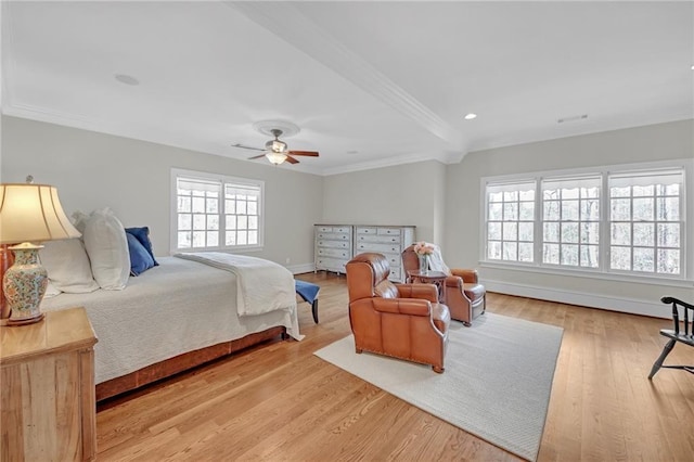 bedroom with a ceiling fan, crown molding, baseboards, and wood finished floors