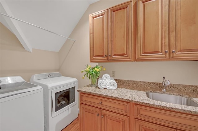 laundry area with a sink, cabinet space, and washing machine and clothes dryer