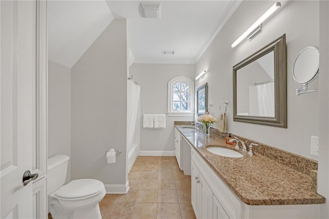 bathroom featuring baseboards, double vanity, a sink, crown molding, and toilet