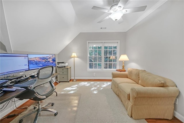 office featuring a ceiling fan, visible vents, baseboards, vaulted ceiling, and crown molding