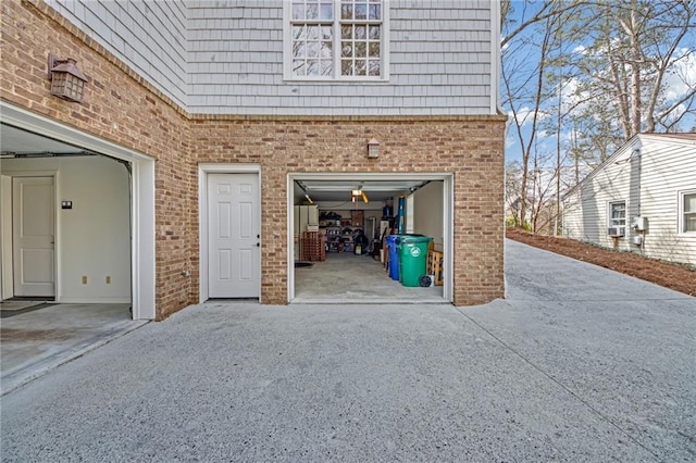 garage featuring concrete driveway