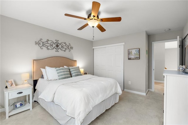 bedroom with light carpet, ceiling fan, and a closet