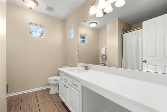 bathroom featuring vanity and toilet