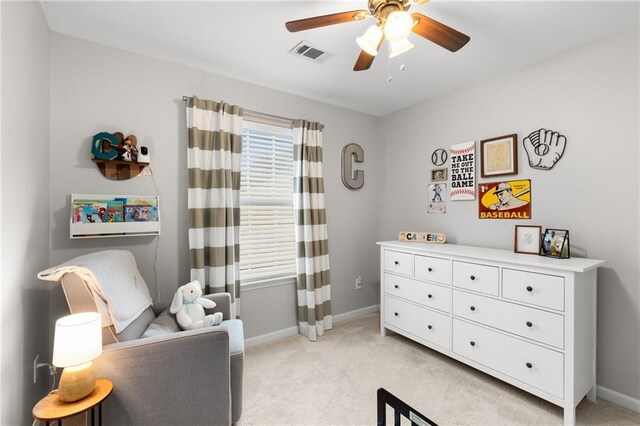 living area with ceiling fan and light carpet