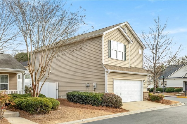 view of side of property with a garage