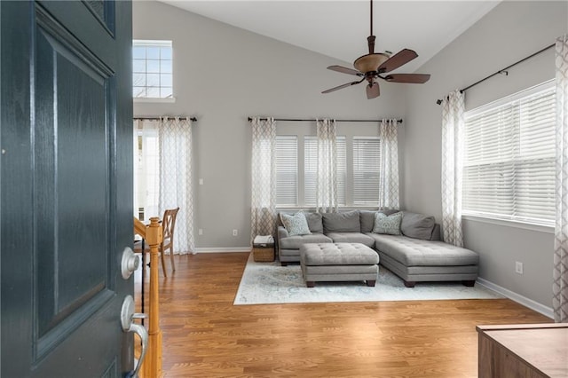 living room featuring ceiling fan, high vaulted ceiling, and light hardwood / wood-style floors