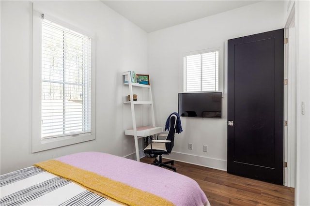 bedroom with dark wood-style flooring and baseboards