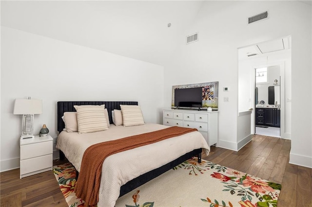 bedroom featuring dark wood-style floors, baseboards, visible vents, and high vaulted ceiling