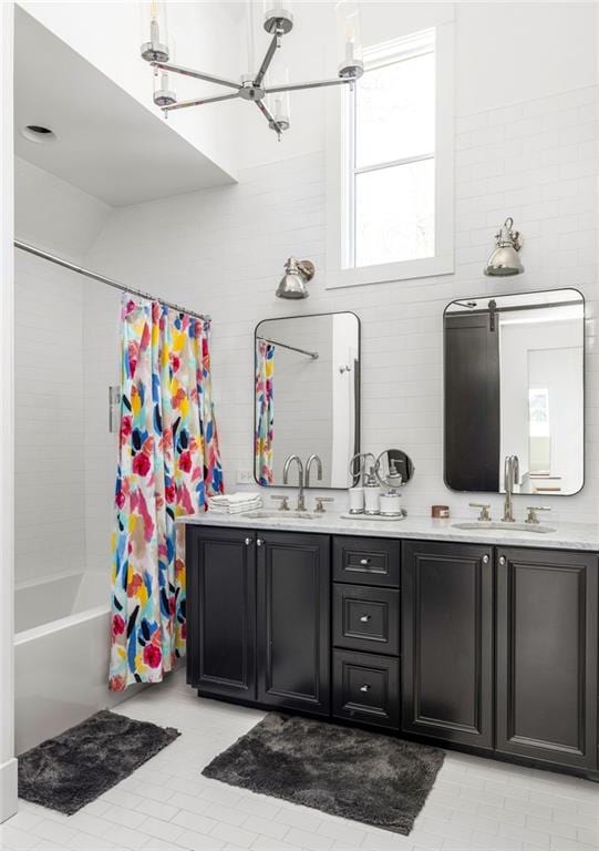 bathroom with shower / tub combo with curtain, a sink, and double vanity