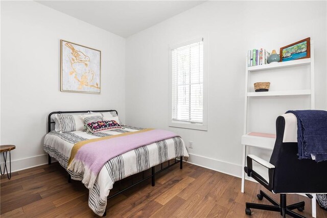 bedroom featuring dark wood-type flooring and baseboards