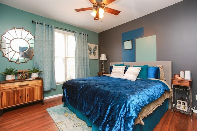 bedroom featuring dark wood-style floors, ceiling fan, and baseboards