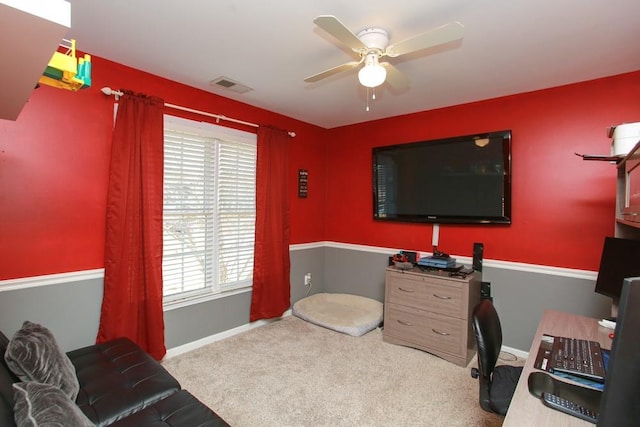 office featuring light carpet, ceiling fan, visible vents, and baseboards