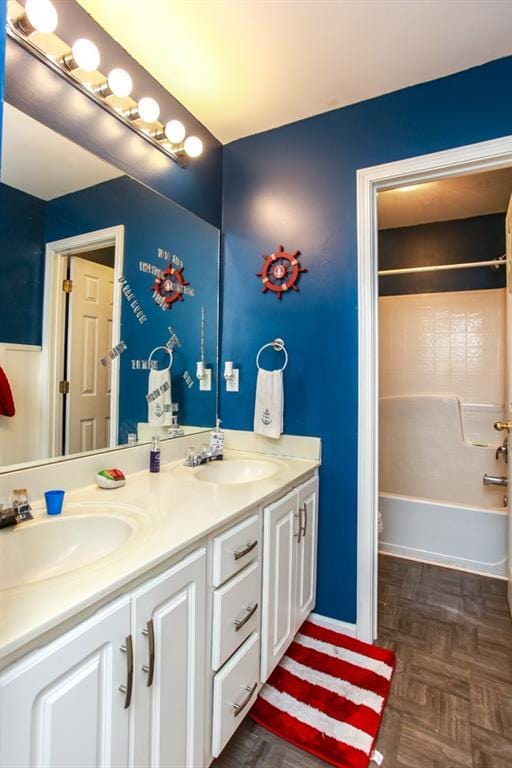 bathroom featuring tub / shower combination, a sink, and double vanity