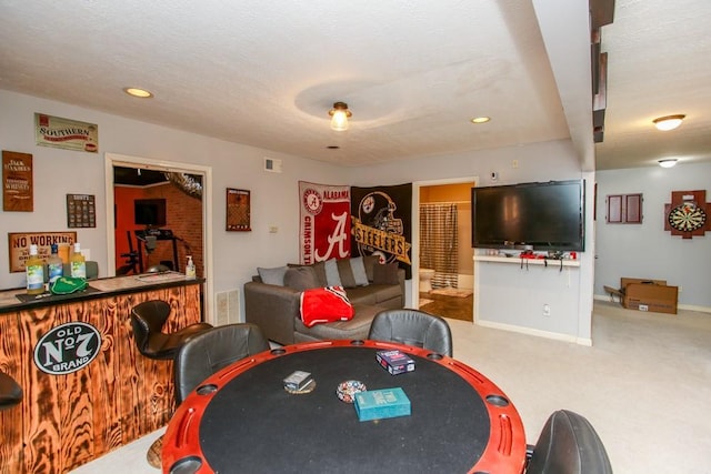 rec room with a bar, carpet, visible vents, and baseboards