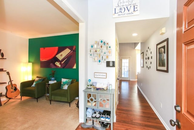 hallway with ornamental molding, dark wood-type flooring, and baseboards