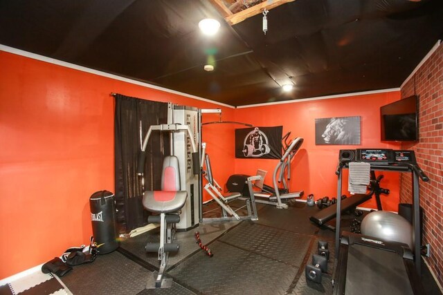 exercise room featuring brick wall