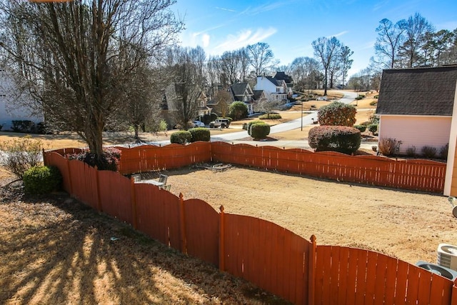 view of yard with fence and a residential view