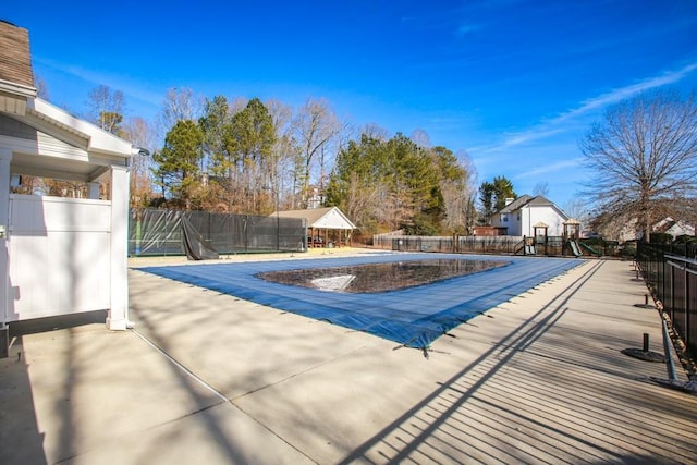 community pool with fence and a patio