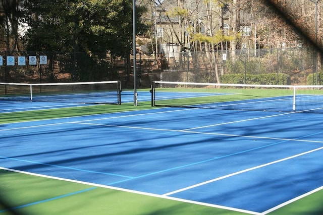 view of sport court featuring fence