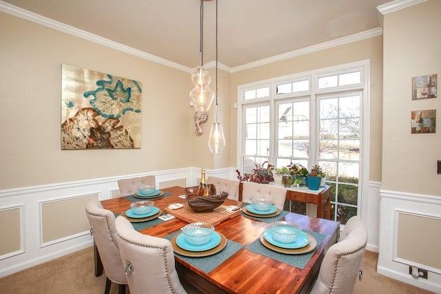 dining space with light carpet, wainscoting, and crown molding