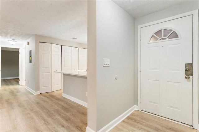 4315 Orchard Park Ct, Stone Mountain, GA 30083 - entryway with a textured ceiling, light wood-style flooring, and baseboards