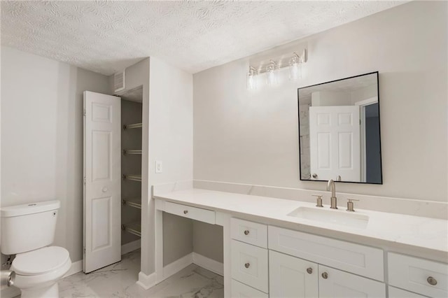 bathroom with marble finish floor, toilet, vanity, and baseboards