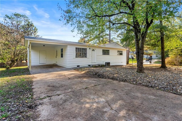 ranch-style home featuring crawl space, driveway, and a carport