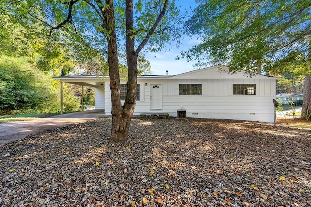 ranch-style house with driveway, a carport, and crawl space