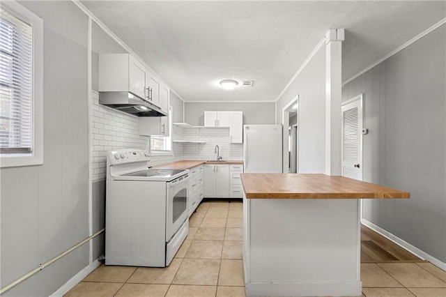 kitchen with white appliances, under cabinet range hood, white cabinetry, open shelves, and a sink