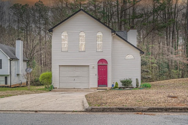 2068 Bedford Ct, Lithonia, GA 30058 - traditional home featuring concrete driveway and a chimney