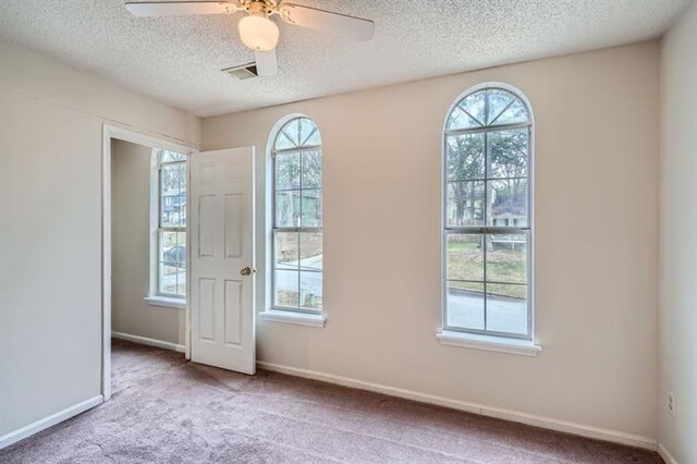 2068 Bedford Ct, Lithonia, GA 30058 - spare room with carpet flooring, a healthy amount of sunlight, baseboards, and ceiling fan