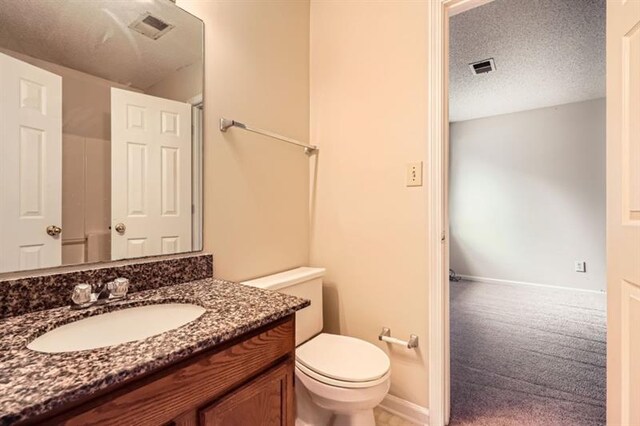 2068 Bedford Ct, Lithonia, GA 30058 - bathroom featuring visible vents, toilet, a textured ceiling, and vanity