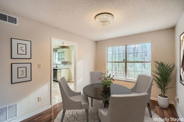 2068 Bedford Ct, Lithonia, GA 30058 - dining room with visible vents, baseboards, and wood finished floors