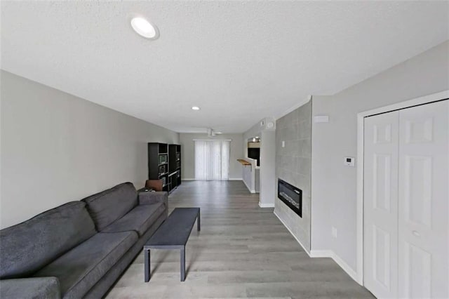 4701 Flat Shoals Rd Unit 50A, Union City, GA 30291 - living area with light wood-type flooring, baseboards, a fireplace, recessed lighting, and a textured ceiling