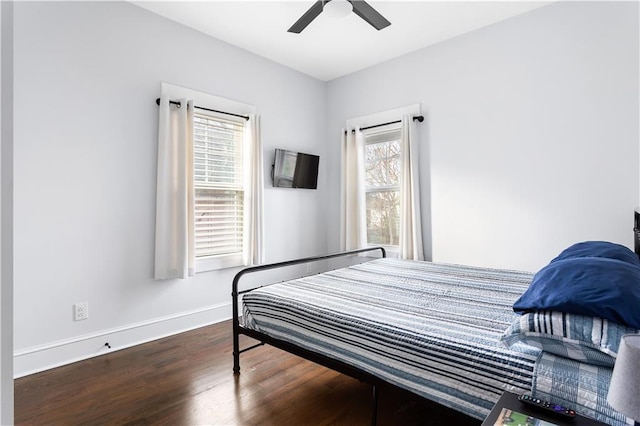 bedroom with ceiling fan and dark hardwood / wood-style flooring