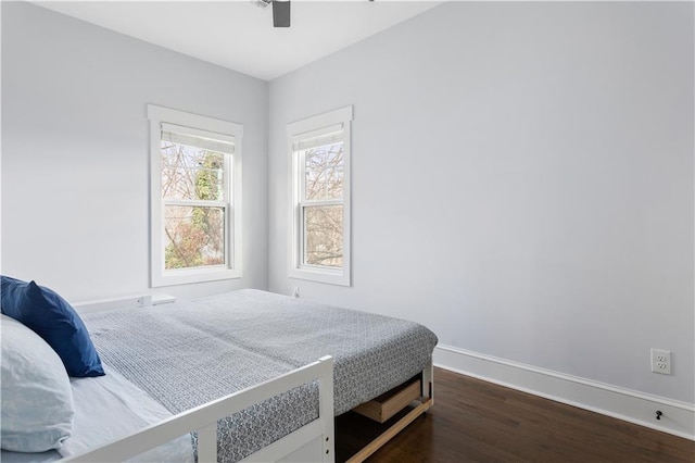 bedroom with ceiling fan and dark hardwood / wood-style flooring