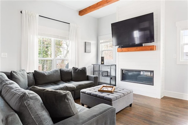 living room featuring a large fireplace, dark hardwood / wood-style floors, and beamed ceiling