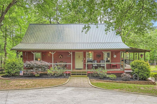 chalet / cabin with covered porch and metal roof