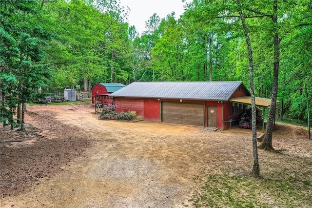 garage with a garage and dirt driveway