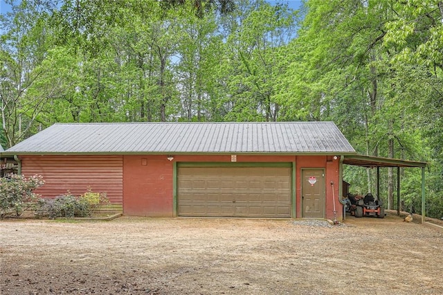 garage with dirt driveway